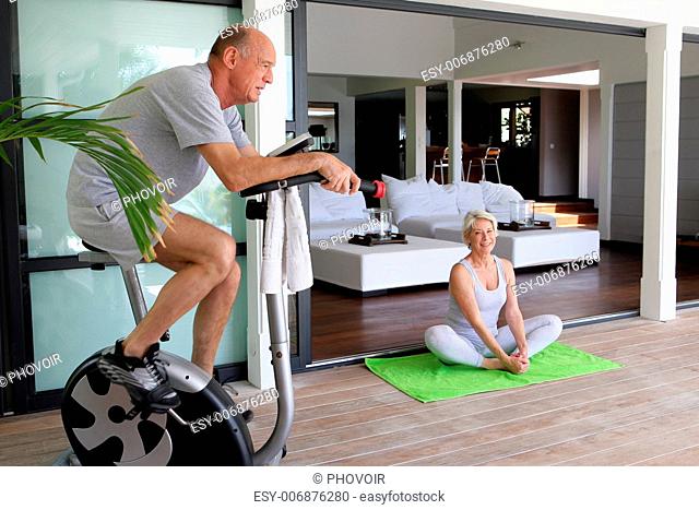 Elderly couple working out at home