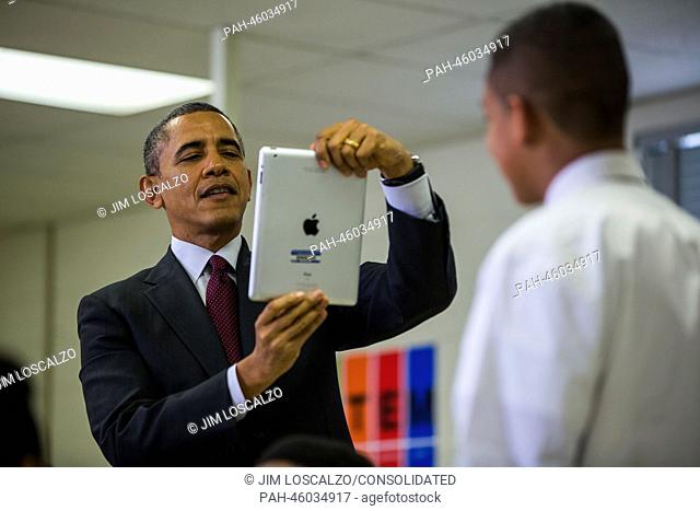 United States President Barack Obama uses an iPad to record a seventh grader in a classroom that uses technology to enhance students' learning experience