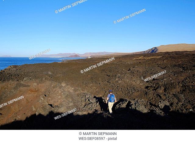 Spain, Canary Islands, Lanzarote, Tinajo, Los Volcanos nature park, women hiking through lava waste