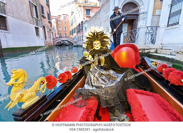 A masked woman during carnival in a gondola on the Canale Grande, Venice, Italy, Europe