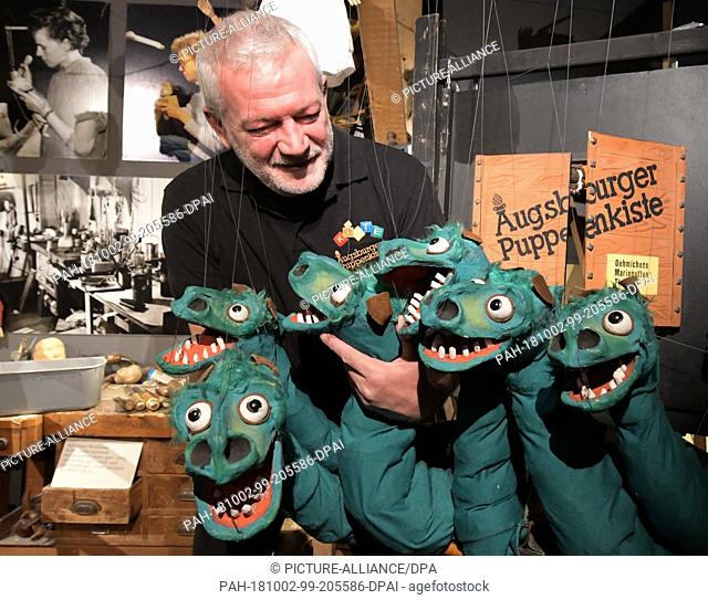 02 October 2018, Bavaria, Augsburg: Klaus Marschall, the director of the Augsburg Puppenkiste, is preparing a puppet monster with several heads in the doll...