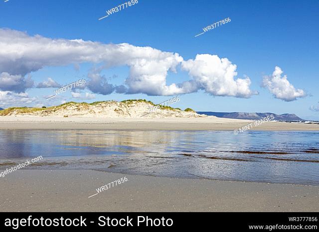 A wide open sandy beach and view along the coastline of the Atlantic ocean