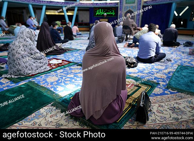 16 July 2021, Hamburg: Muslims take part in Friday prayers at the Imam Ali Mosque of the Islamic Center Hamburg (IZH). According to the Hamburg Office for the...