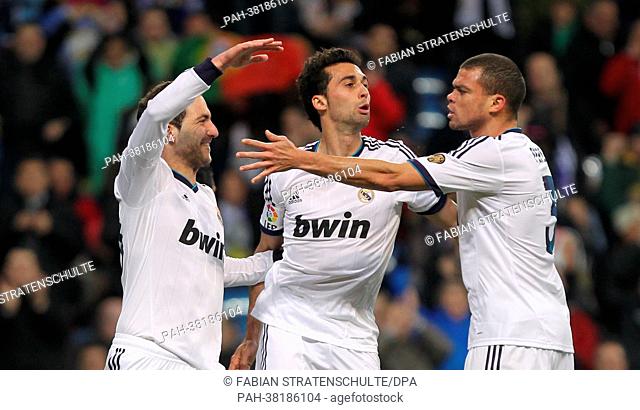 Real Madrid's Gonzalo Higuain celebrates his 1:1-equalizer with José Callejon and Pepe (L-R) during the Spanish Primera Division soccer match between Real...