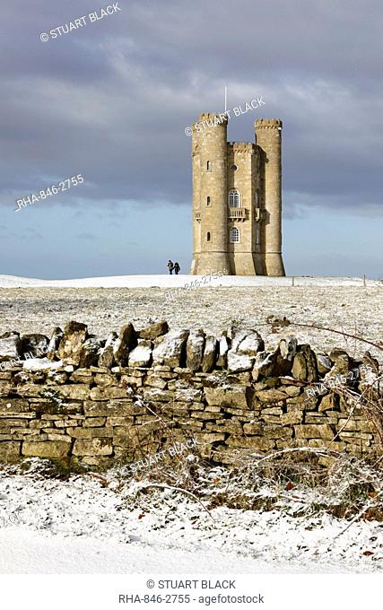 Broadway Tower and Cotswold drystone wall in snow, Broadway, Cotswolds, Worcestershire, England, United Kingdom, Europe