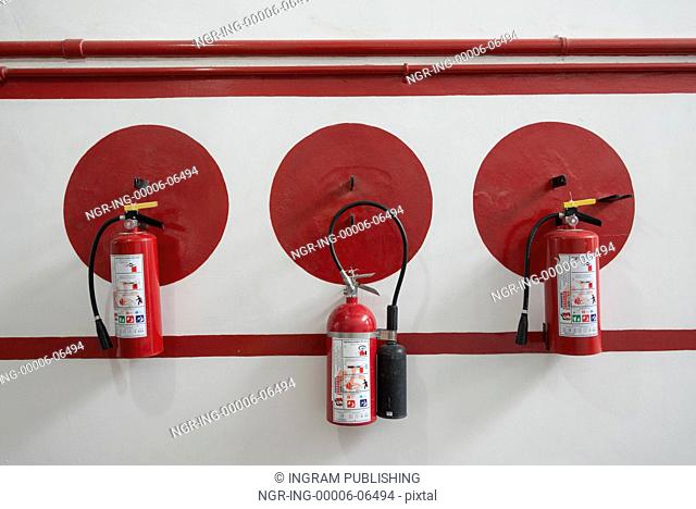 Fire extinguishers hung on awall, Fabrica La Aurora, San Miguel de Allende, Guanajuato, Mexico