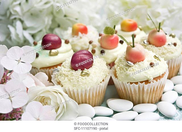 Cupcakes decorated with marzipan fruits and hortensia flowers