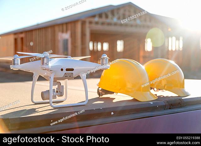 Drone Quadcopter Next to Hard Hat Helmets At Construction Site
