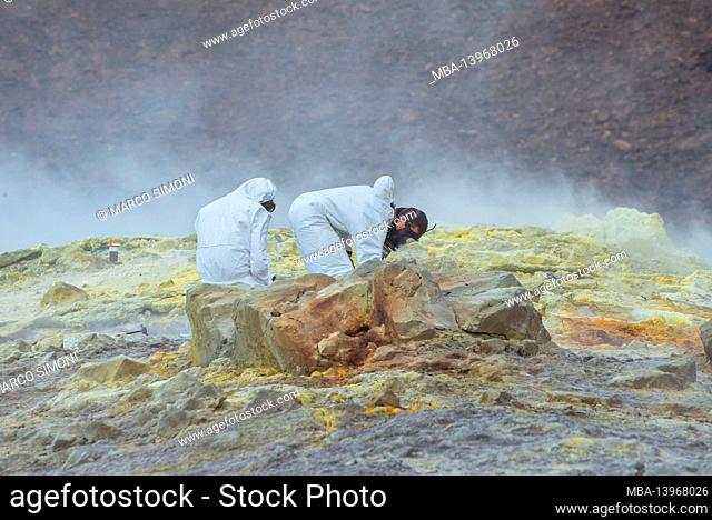 Volcanologists collecting minerals samples on Gran Cratere, Vulcano Island, Aeolian Islands, Sicily, Italy