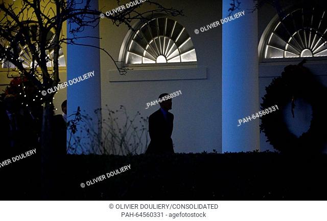 United States President Barack Obama walks from the Oval Office to the residence to meet with the First Family to depart the White House in Washington, DC