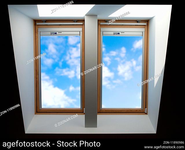 double roof windows overlooking the blue slightly cloudy sky
