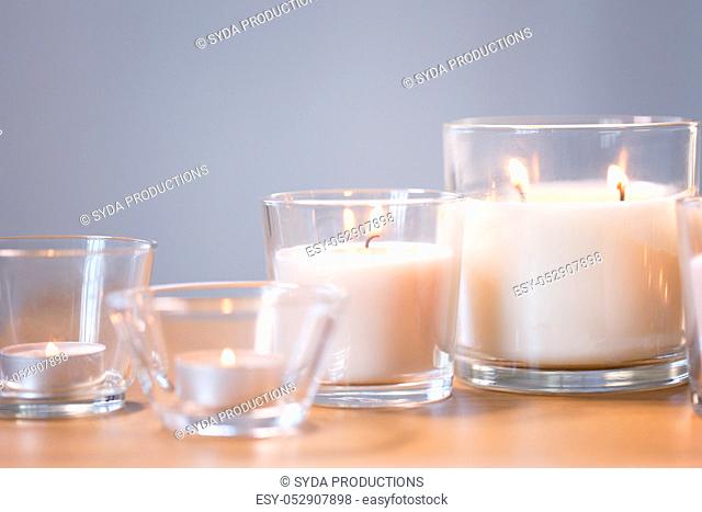 burning white fragrance candles on wooden table