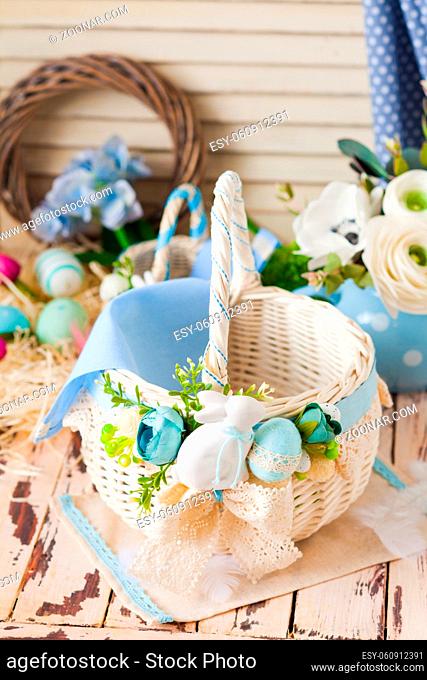 Top view white wicker basket, arrayed with lace and artificial flowers. Spring floral design for traditional Easter holidays. Light crained top
