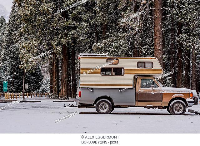 Campervan parked on snow covered ground, Yosemite National Park, California, USA
