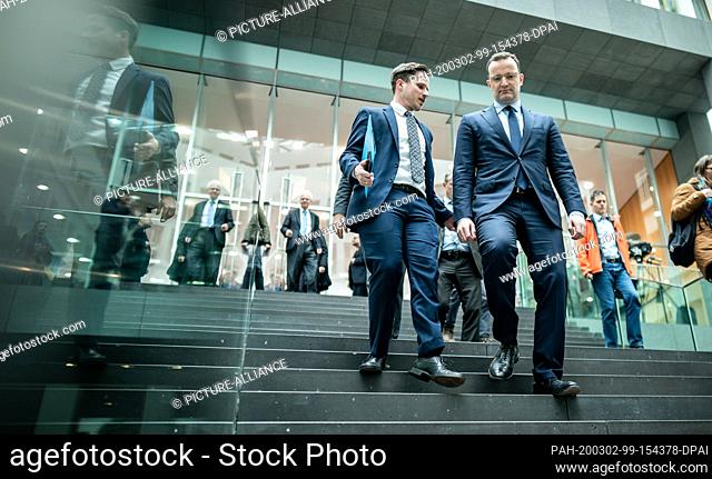 02 March 2020, Berlin: Jens Spahn (CDU - r), Federal Minister of Health, leaves a press conference on the further development of coronavirus infections along...