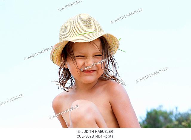 Cute girl in sun hat, portrait, Scopello, Sicily, Italy