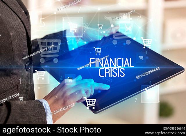Young person makes a purchase through online shopping application with FINANCIAL CRISIS inscription
