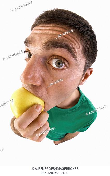 Man biting into an apple, fish-eye lens
