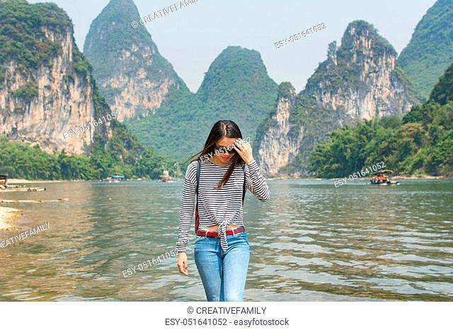 Beautiful tourist girl at Li River in Yangshou, China
