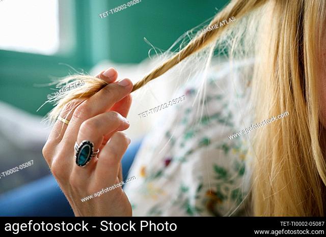 Fiddling with her hair Stock Photos and Images | agefotostock