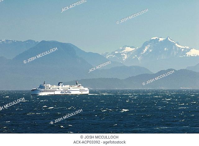 A BC Ferry crosses the Strait of Georgia under a menacing sky, british columbia, canada