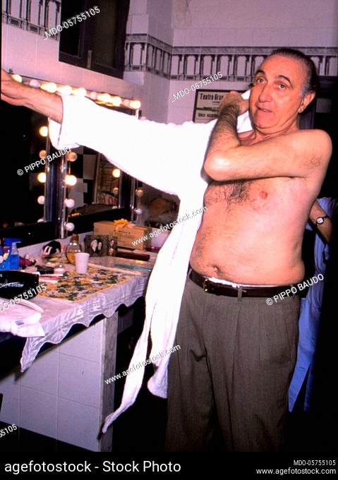 Italian television host Pippo Baudo get dressed in the backstage. Italy, 1990s