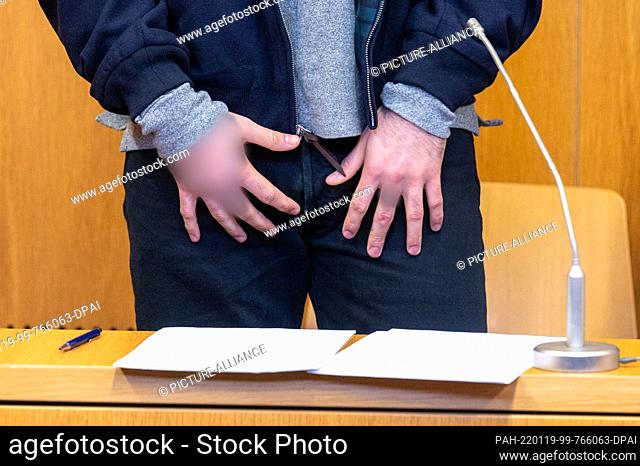 19 January 2022, Bavaria, Landshut: The defendant stands in the hearing room of the district court. The prosecution accuses the 25-year-old man of shooting a...