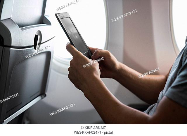Man using ebook in airplane