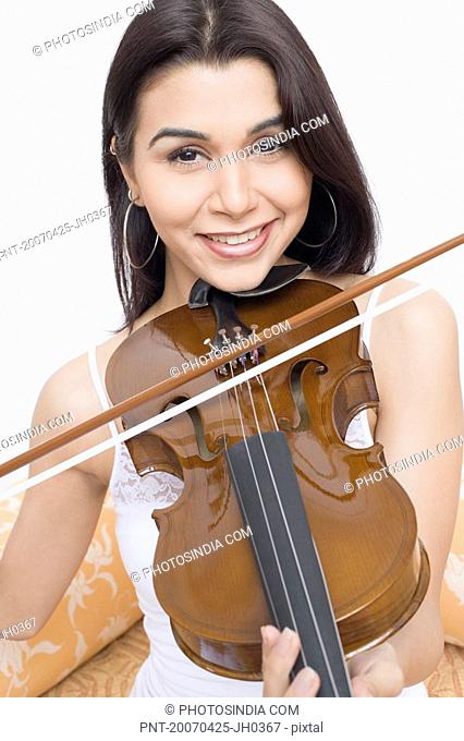 Portrait of a young woman playing a violin