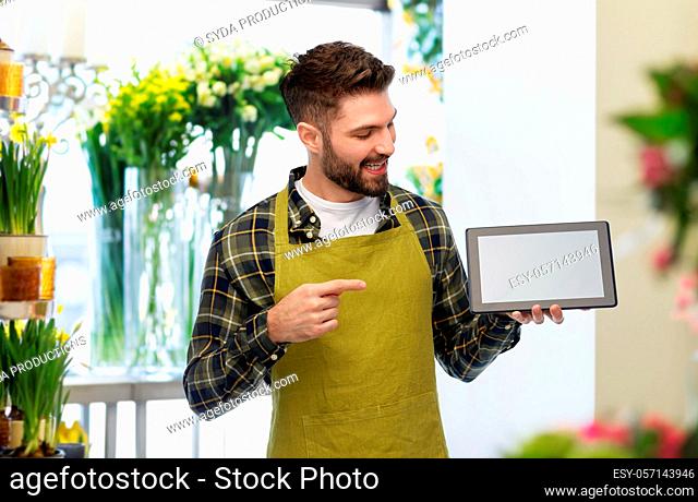 happy male gardener or farmer with tablet pc