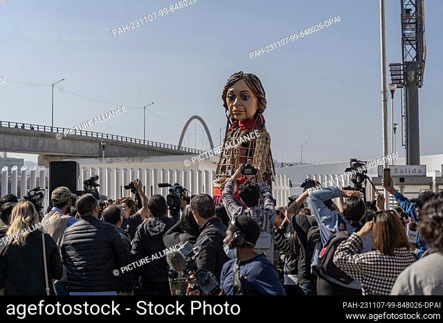 06 November 2023, Mexico, Tijuana: The doll ""Little Amal"" from the art project ""The Walk"" is used at the border with the USA. The 3
