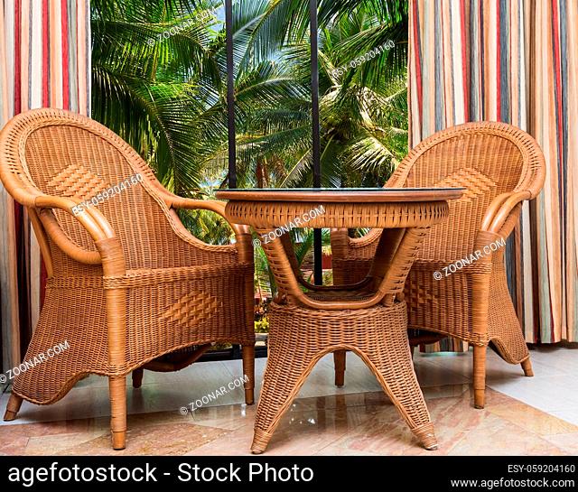 paradise hotel view from the window on the palm trees beach furniture rattan