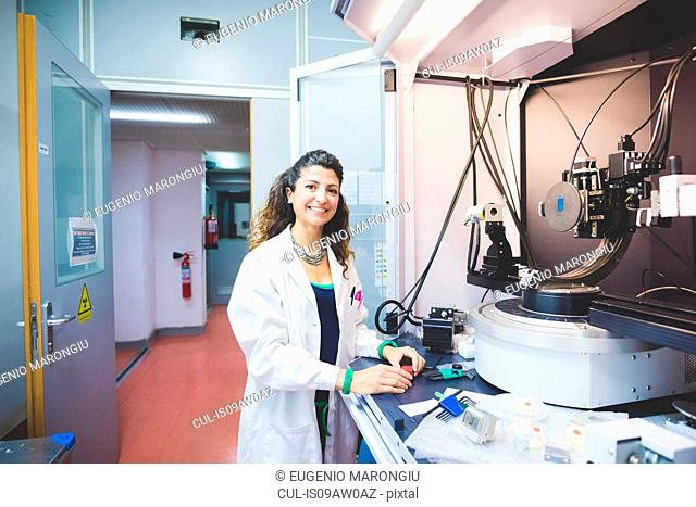 Female scientist preparing x-ray diffractometer