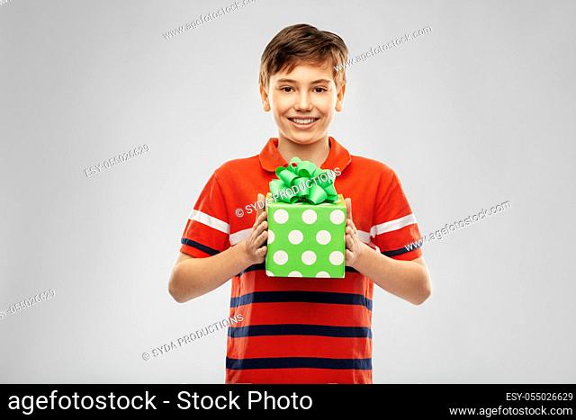 portrait of happy smiling boy with gift box