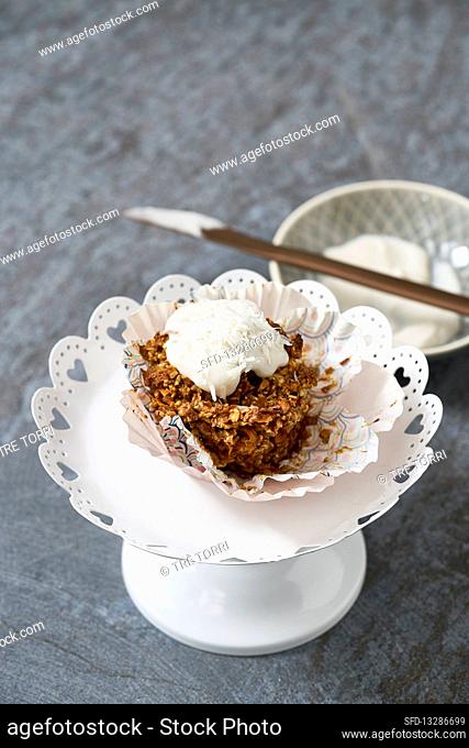A carrot cupcake with coconut yoghurt