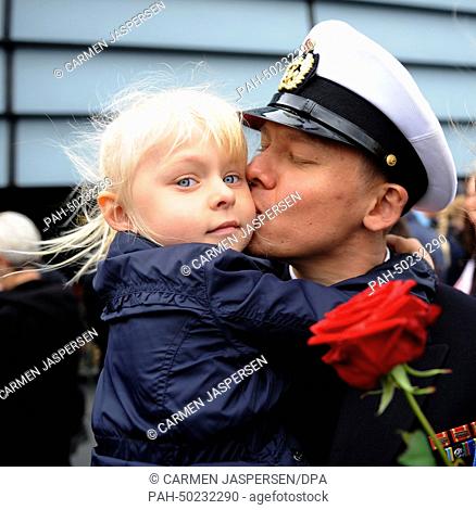 Crew member of the frigate Augsburg, Nikolai Bajew, kisses his daughter Emilia on the deck of the frigate after the frigate's return to the naval base in...