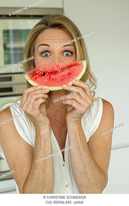 Mature woman holding watermelon