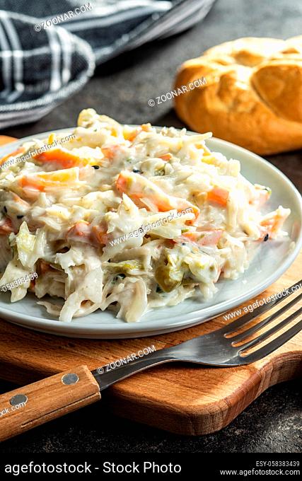 Coleslaw. Salad made of shredded white cabbage and grated carrot with mayonnaise on plate