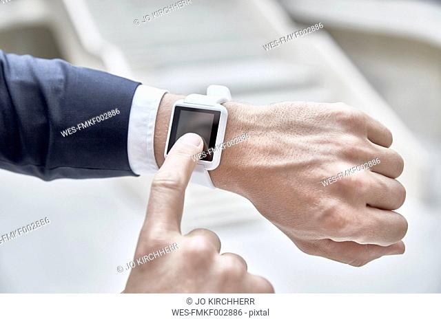 Businessman touching smartwatch