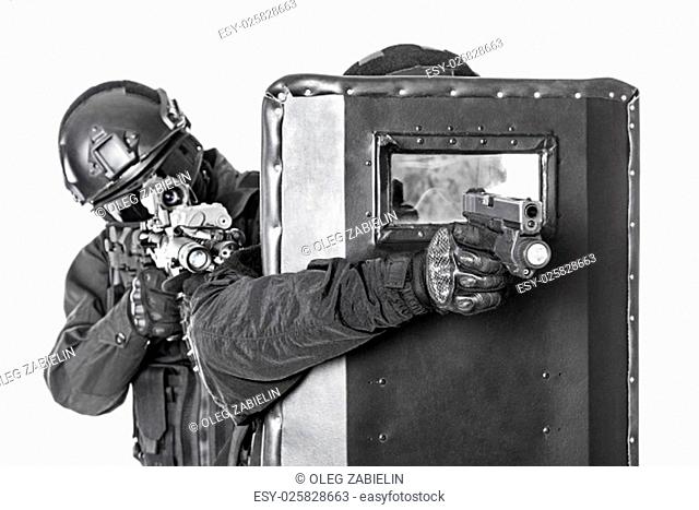 Spec ops police officers SWAT with ballistic shield studio shot