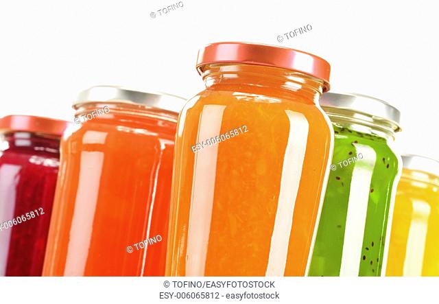 Jars of fruity jams isolated on white background. Preserved fruits