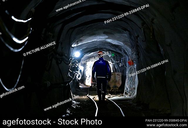 dpatop - PRODUCTION - 12 December 2023, Saxony, Bad Schlema: Foreman Jörg Neubert walks underground through a restored roadway on the Markus-Semmler level of...