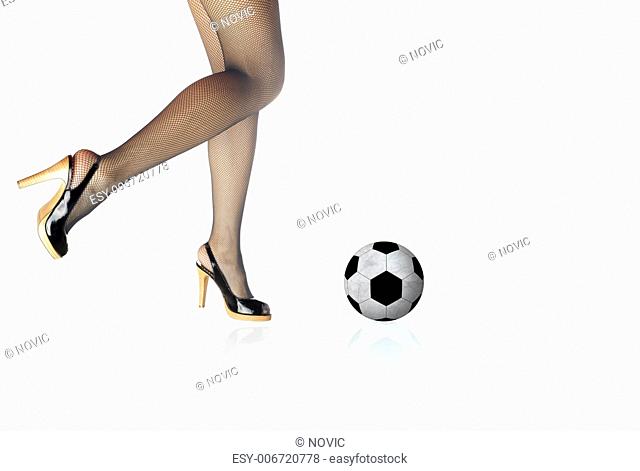 Graceful legs and football on a white background