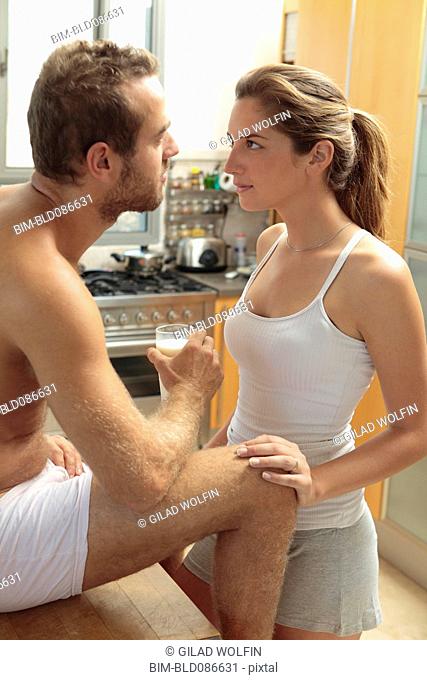Caucasian couple in pajamas in kitchen