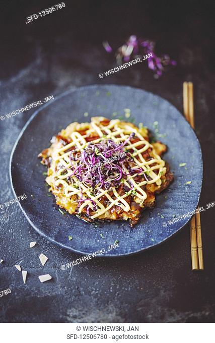 Okonomiyaki (pancake with cabbage, red ginger and bonito flakes, Japan)
