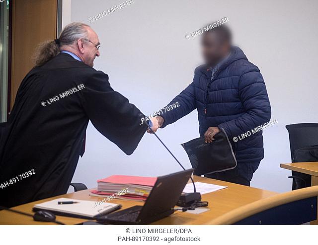 The defedant (R) in a trial concerning suspected support for an overaseas terrorist network is greeted by his lawyer Guenter Urbanczyk in room 18 of regional...