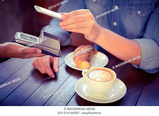 Male customer paying with smartphone