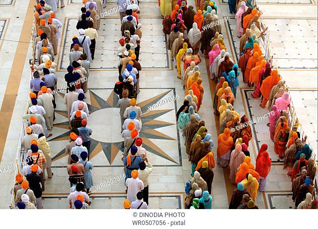Sikh devotees in queues during celebration of consecration of perpetual Guru Granth Sahib in compound of Sachkhand Saheb gurudwara , Nanded , Maharashtra