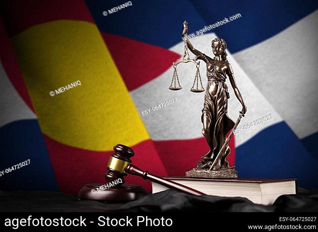Colorado US state flag with statue of lady justice, constitution and judge hammer on black drapery. Concept of judgement and punishment