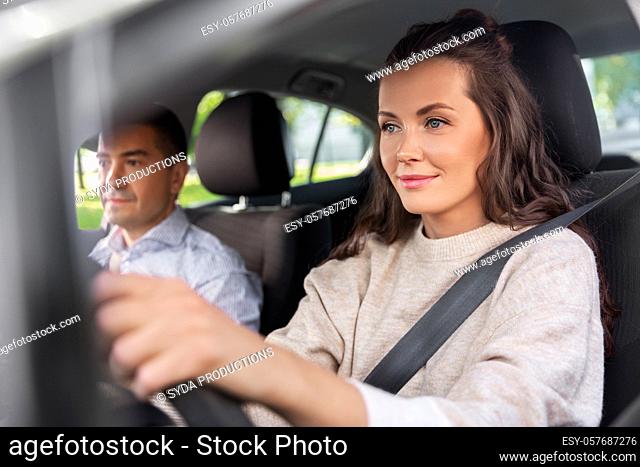 woman and driving school instructor in car